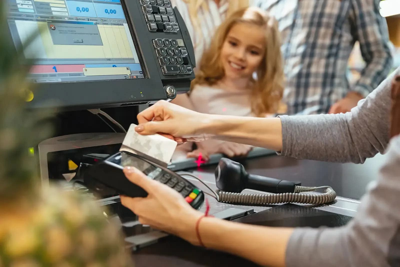 Cashier completing a card payment at a retail checkout