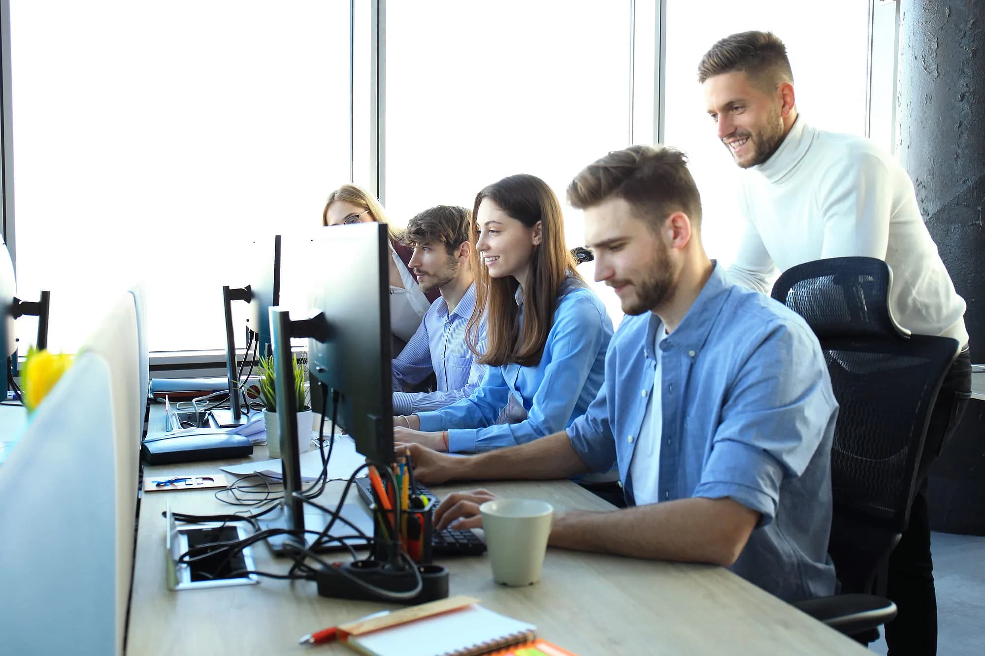 A product team reviewing a build together at a shared desk