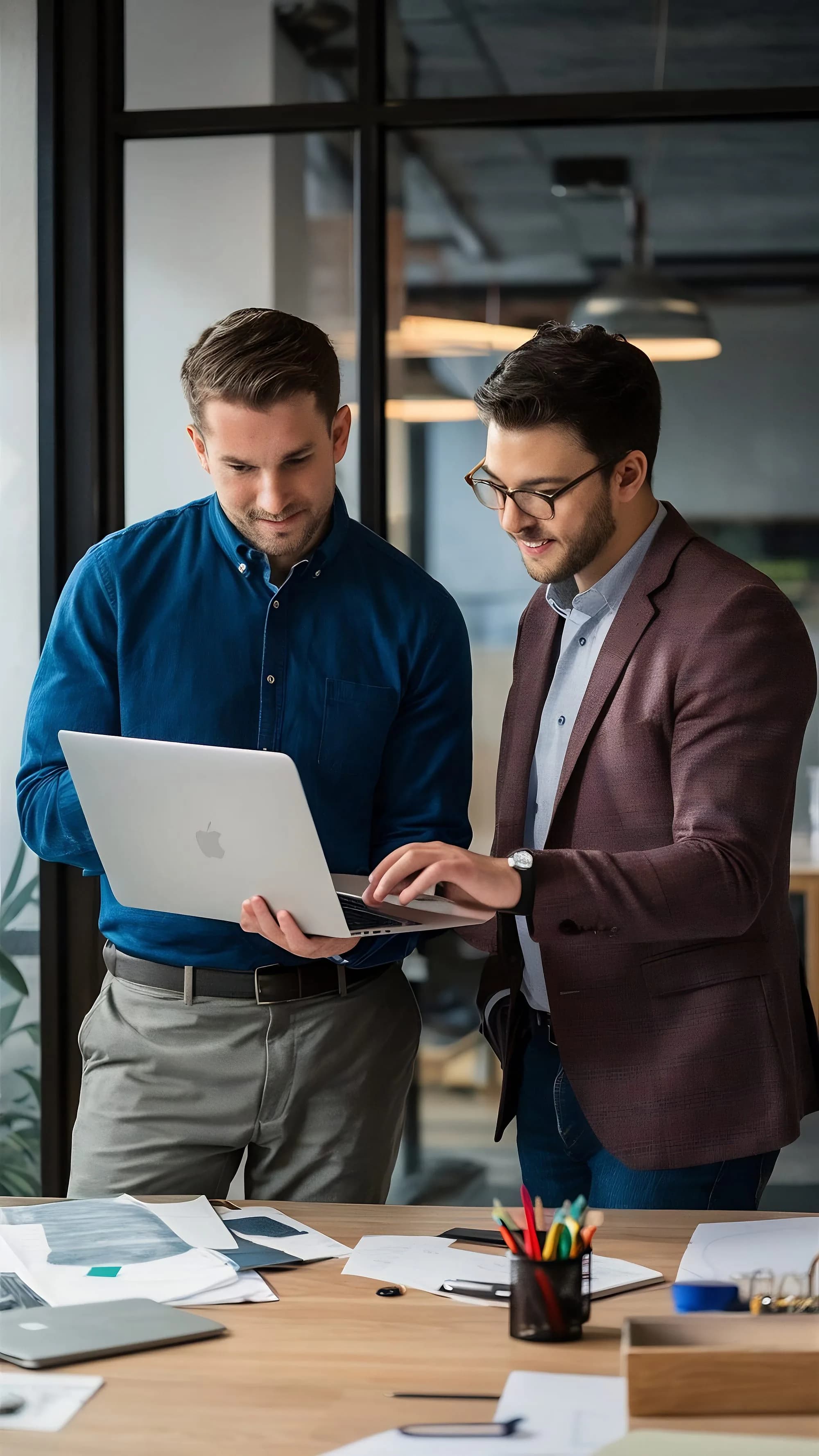 Two colleagues working through a customer's question together on a laptop